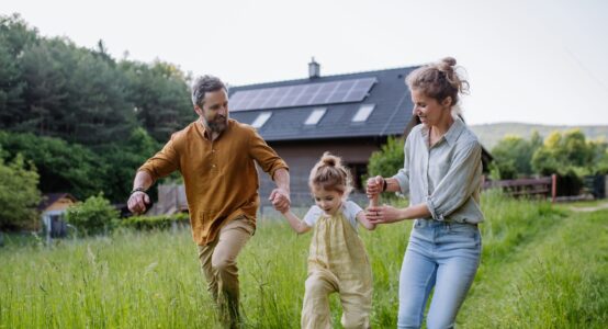 A young family playing in a garden.