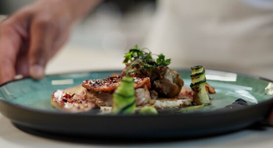 A chef prepares a dish in a fine dining restaurant.