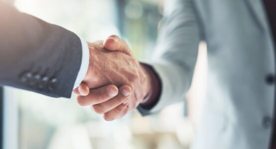 Two people shaking hands.