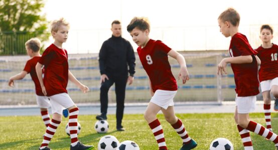 A children’s football coach watching a training session.
