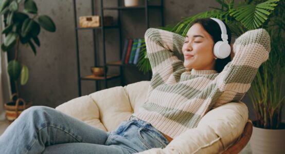 A woman relaxing with headphones on.
