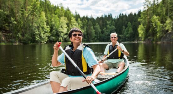 A couple on holiday taking a canoe ride.