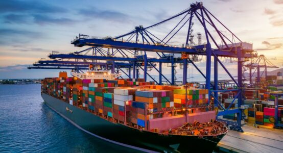 A container cargo ship at a commercial dock.