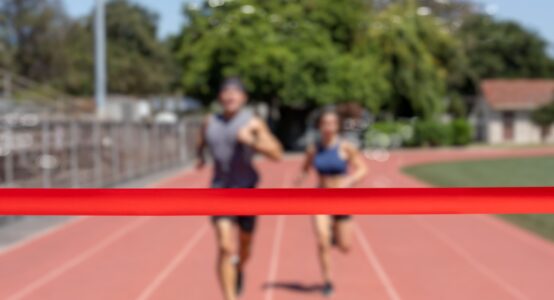Runners running towards a finish line.