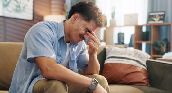 A stressed man with his head in its hand.