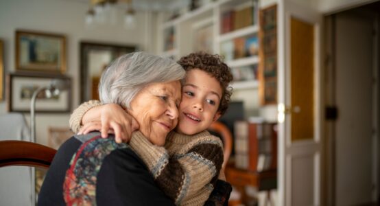 A woman hugging her grandchild.
