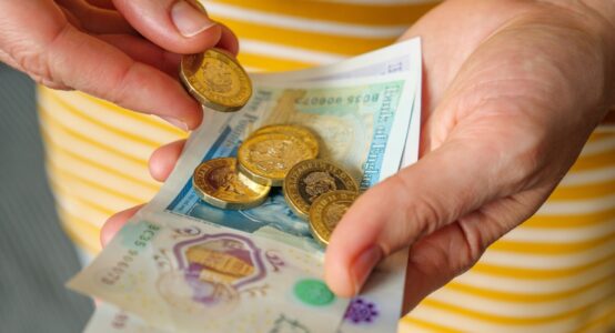 A woman holding cash in her hands.