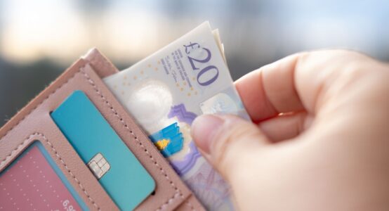 Someone taking money out of a wallet.