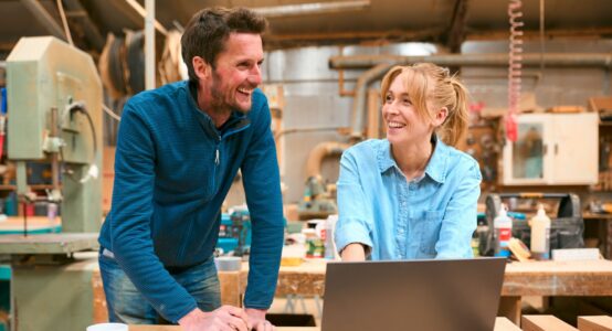 Two people in a woodwork workshop.
