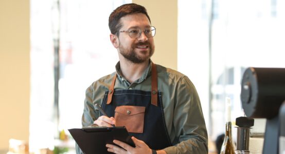 business owner with a clipboard inspecting work.