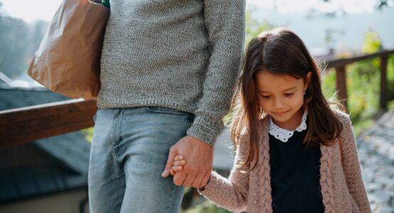 A mother and daughter holding hands