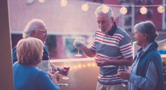 A group of people taking and drinking wine.