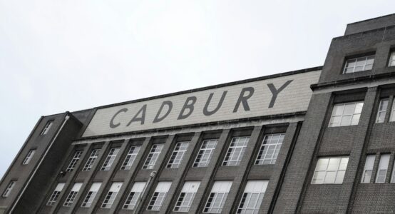 greyscale image of old English building with Cadbury sign across the front