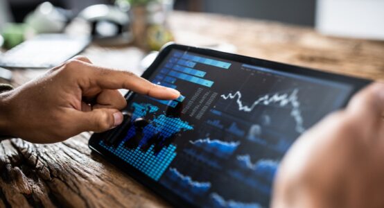 A person reviewing investment performance on a tablet.